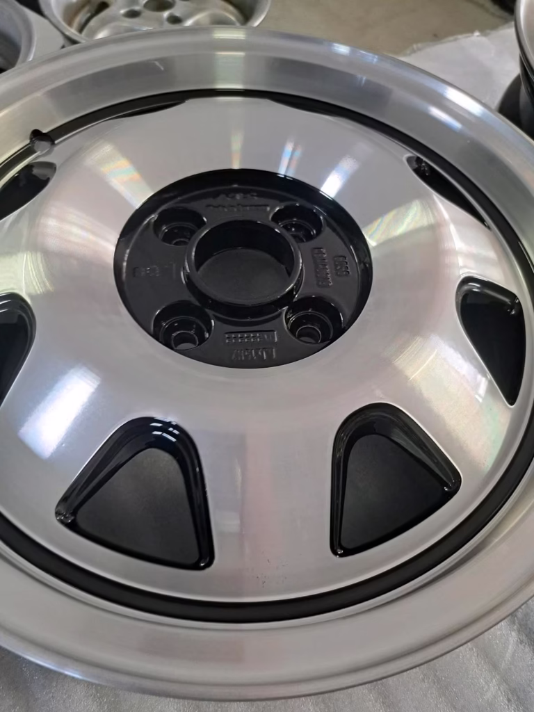 Nahaufnahme einer AtsCup Alufelge 5.5x15 5555, frisch aufgearbeitet mit Metallic-Lackierung und schwarzen Akzenten - ideal für Scirocco oder Golf1 Fans.